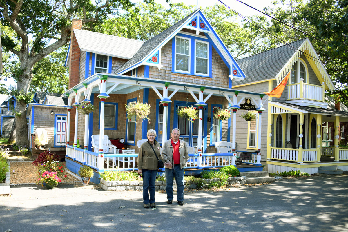 205 Carolyn and Clarence Hoffman pose in front of one of the Gingerbread Houses.jpg